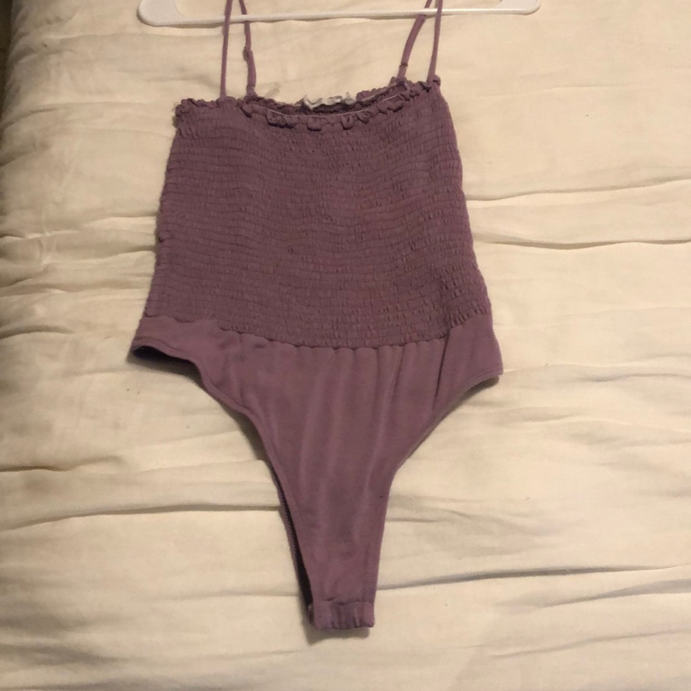 Purple smocked body suit. Never worn. Large.
